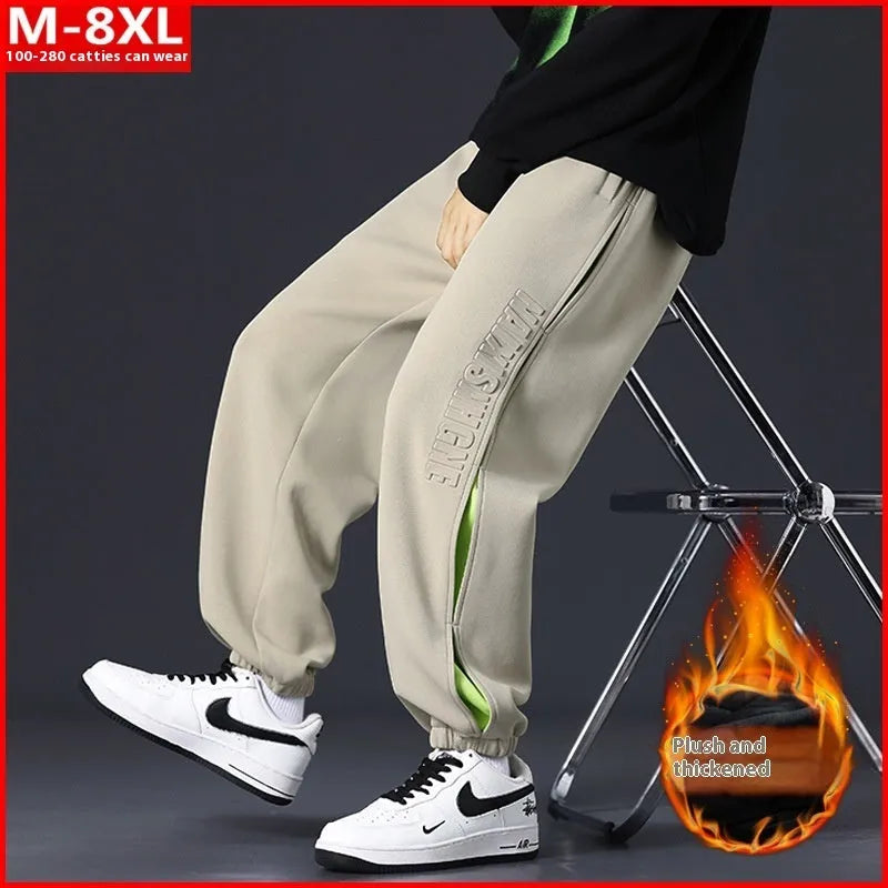Men's loose fit cotton pants with elasticated ankle bands in grey green colour, showing collage stitching detail.