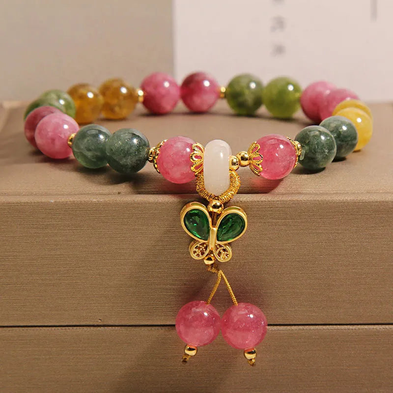 Women's tourmaline bracelet with a natural jade colour butterfly pendant and rhinestone details.