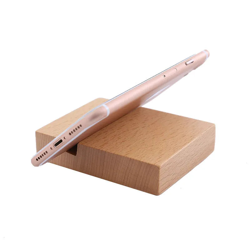Beech wood and resin lazy bracket mobile phone holder in an animal design style on a desk.