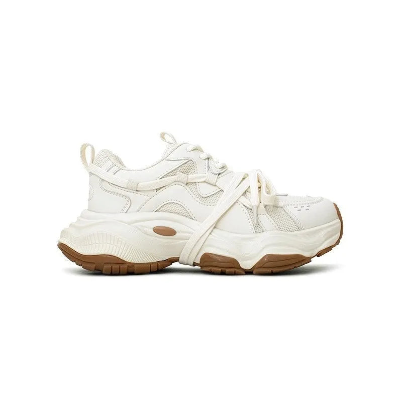 Women's beige and white platform sneakers with round toe and front lace-up design on a composite sole.