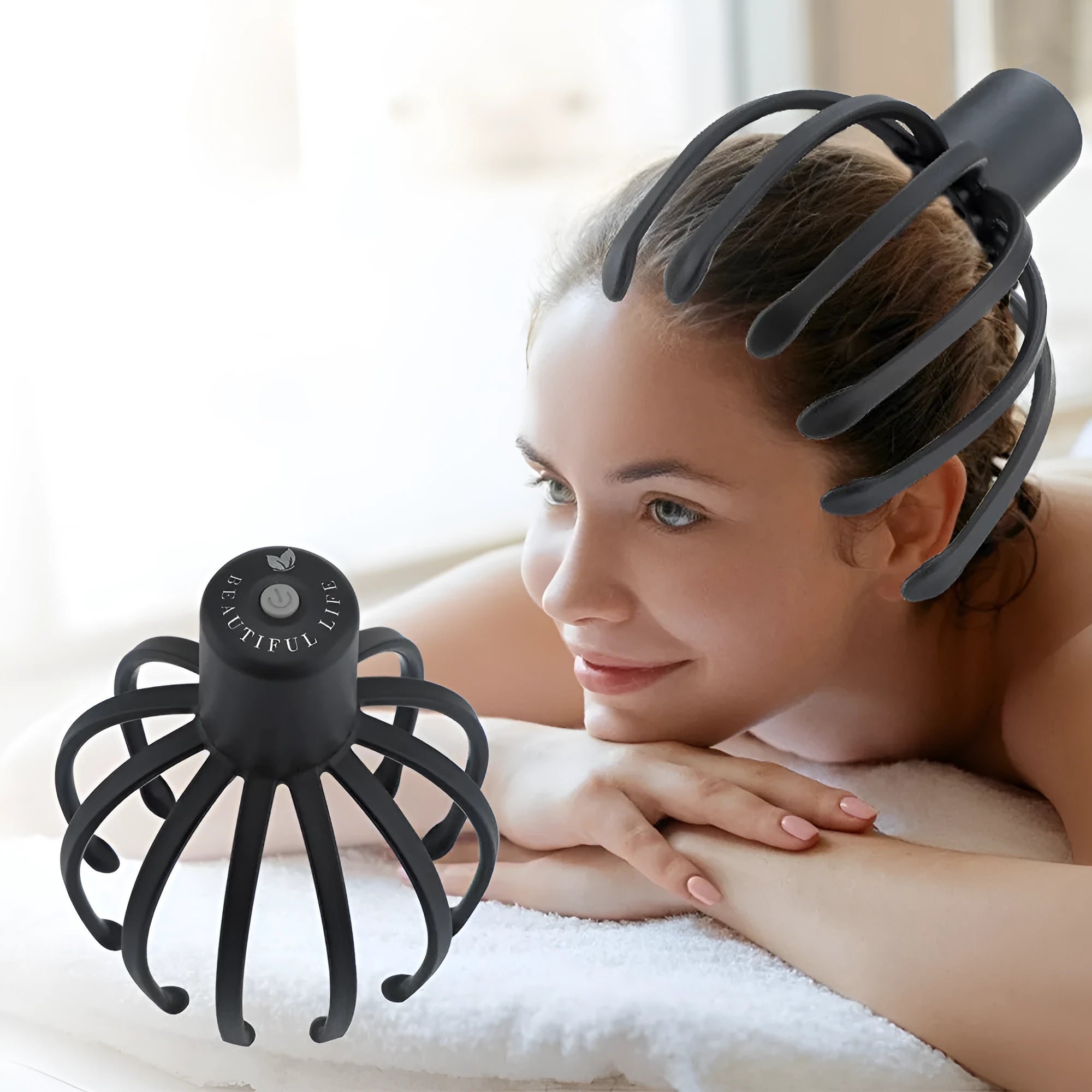 Black electric scalp massager with 12 TPE flexible massage arms and USB charging cable on white background