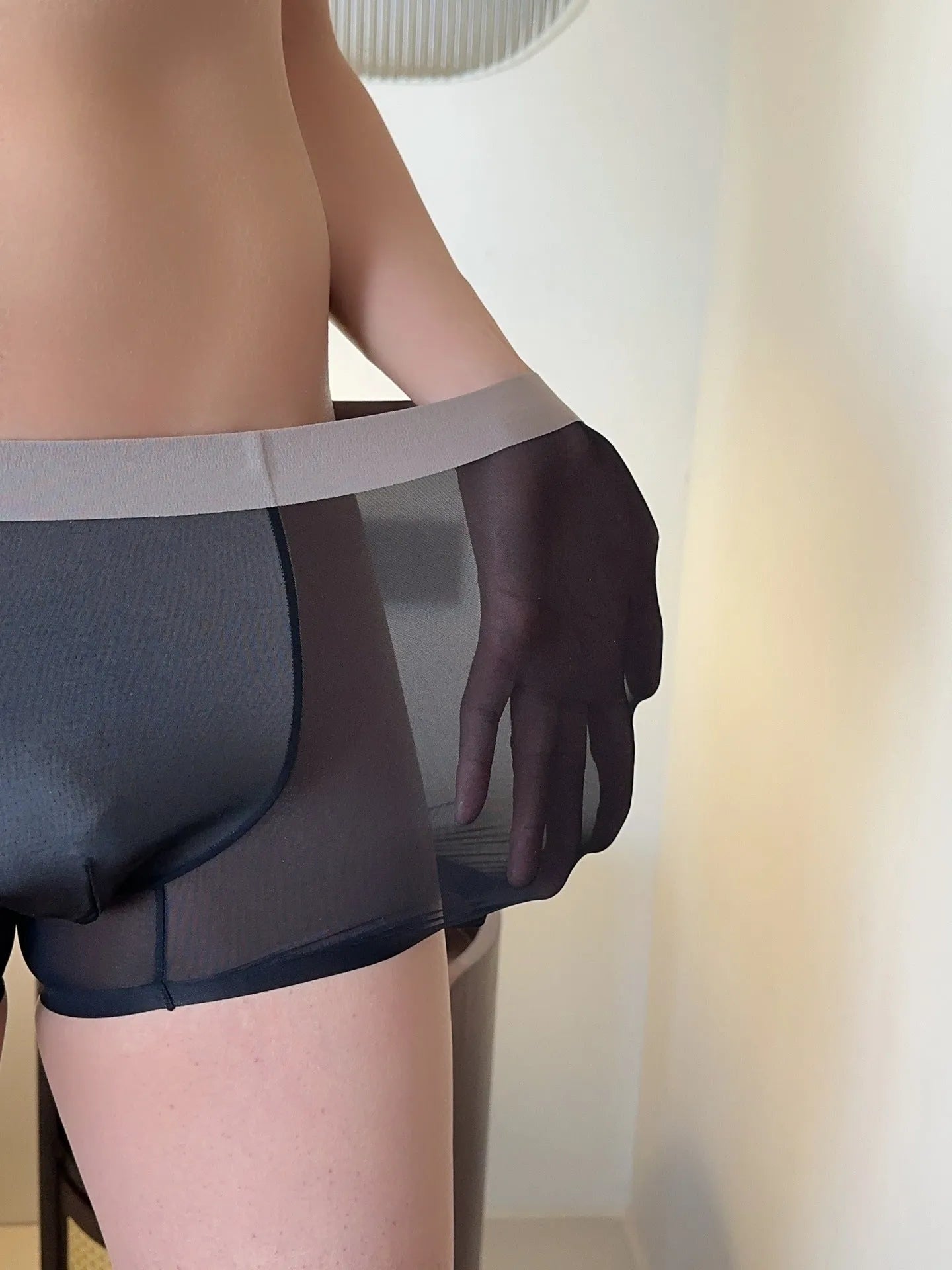 Ultra-thin antibacterial seamless men's boxers in honeycomb fabric on a colour swatch background.