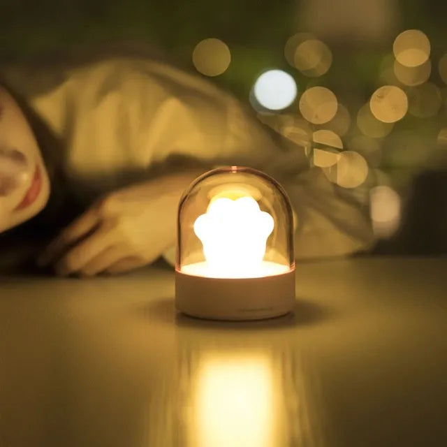 Grey cat paw shaped USB rechargeable night light with music box function on wooden desk