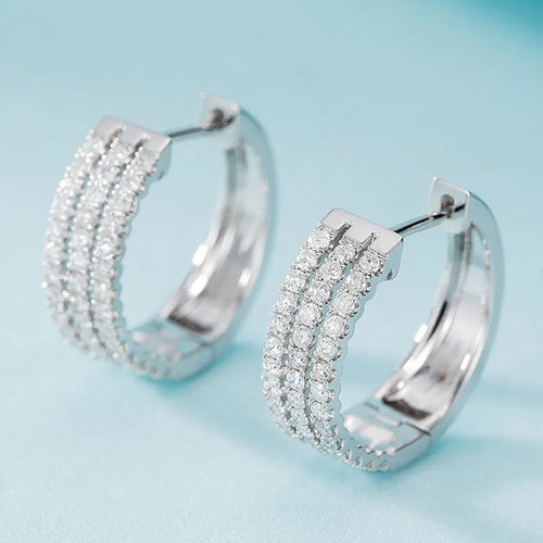 18K white gold natural diamond earrings with 56 point diamond in platinum finish on light background