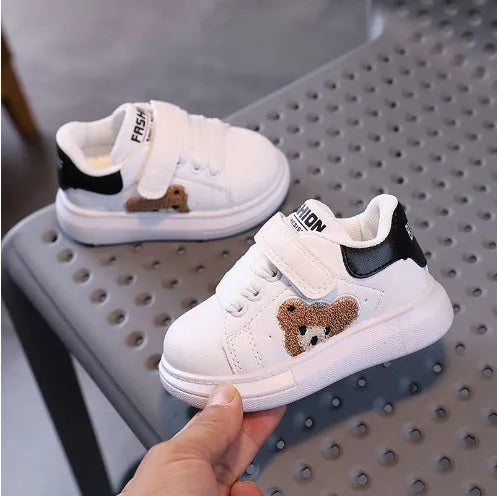 Children's black cartoon bear casual sports shoes with artificial leather upper and rubber sole.
