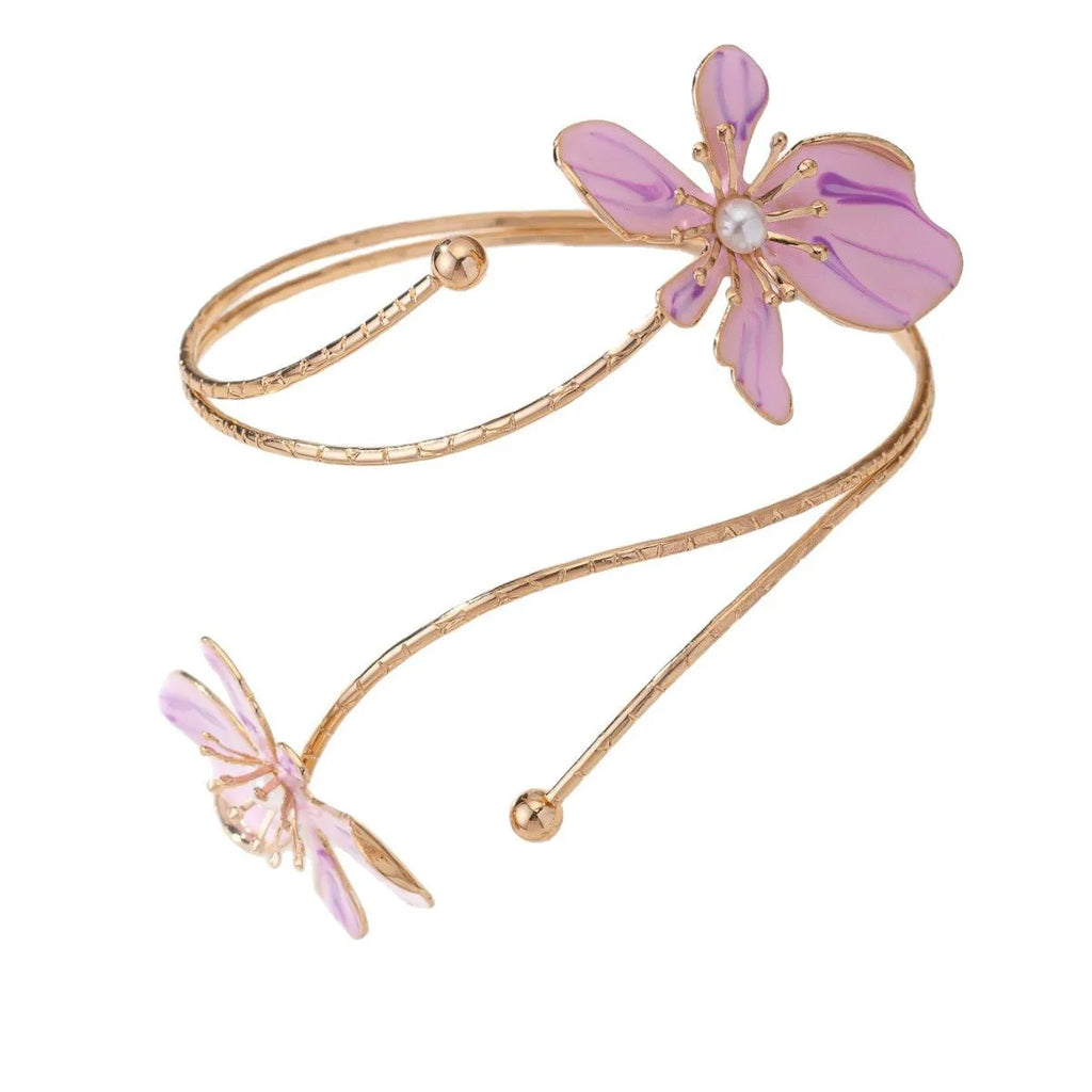 Close-up of a pink alloy arm ring with a hollow line pattern, shown on a wrist.