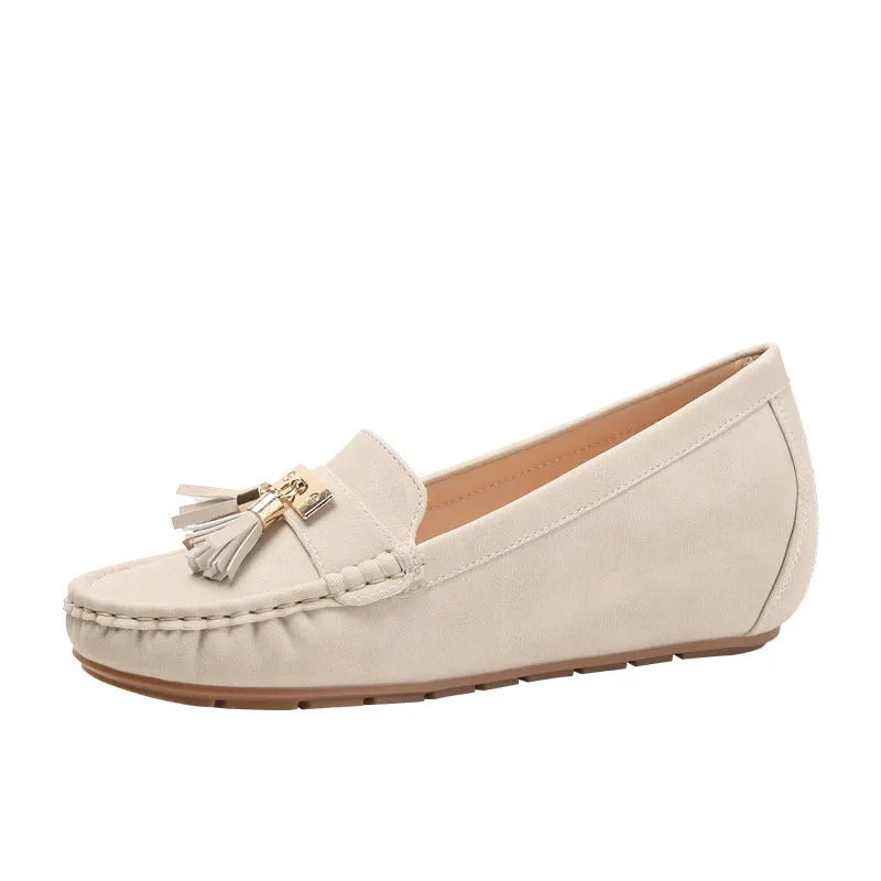 A pair of nude-coloured height-increasing shoe insoles with a round toe and a raised heel section.