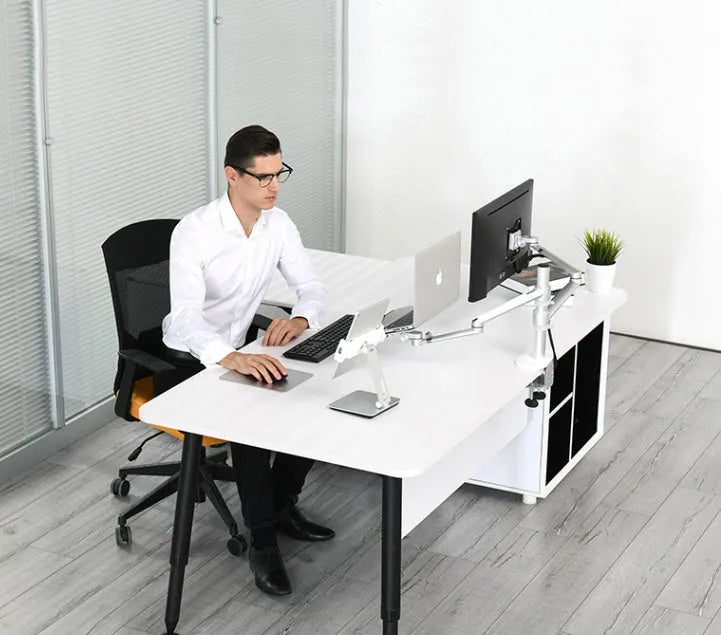 Silver foldable aluminium phone and tablet stand on a desk, holding a tablet at an angle.