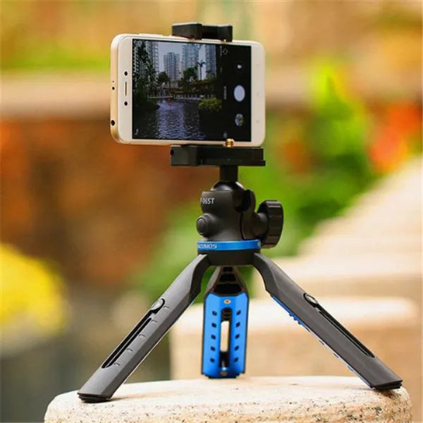 Black plastic and aluminium desktop tripod holding a mobile phone for video calls.