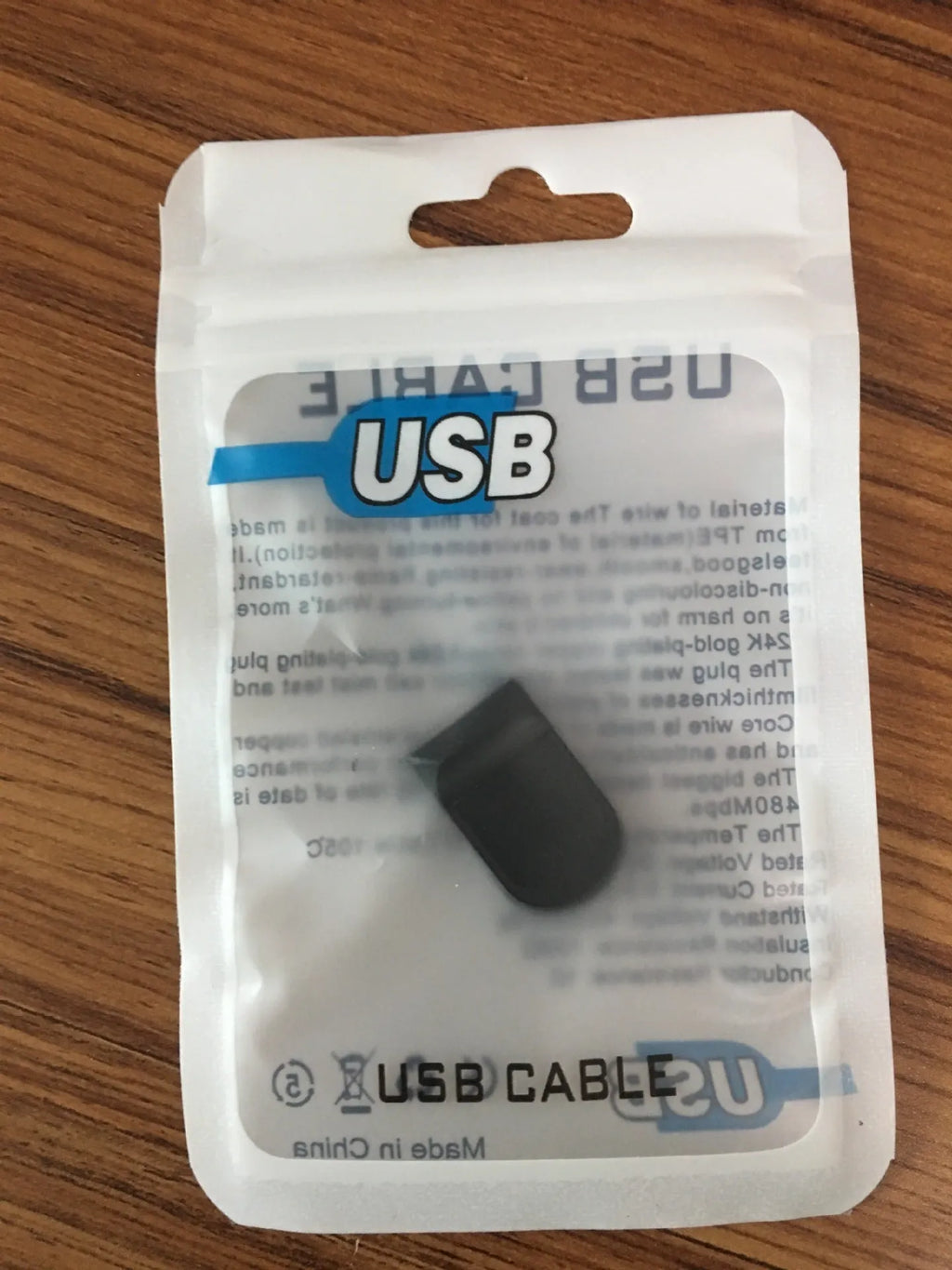 Black plastic USB 2.0 flash drive measuring 2.3 x 1.5 x 0.8 cm with paper card packaging