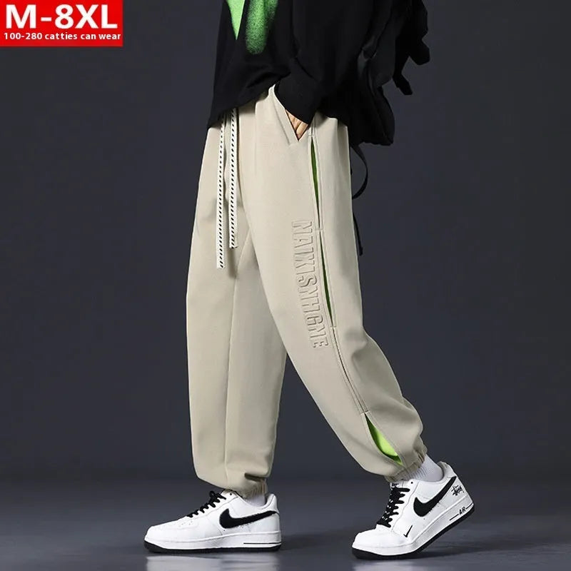 Men's loose fit cotton pants with elasticated ankle bands in grey green colour, showing collage stitching detail.