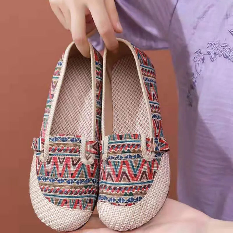 Women's flat heel ethnic cloth shoes in red, green, black, beige, or blue with colour stitching and a shallow mouth.