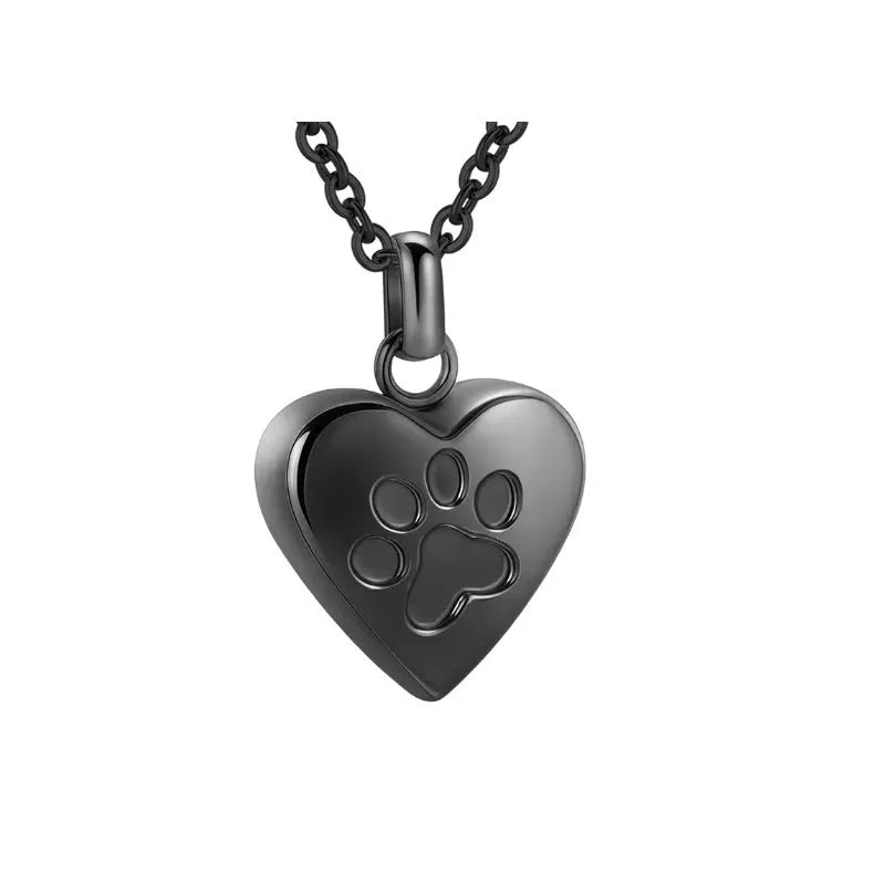 Silver heart pendant necklace with paw print design that opens as a casket.