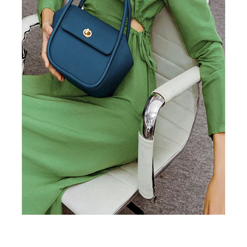 Wing shape cow leather cross-body handbag with buckle detail and fabric lining