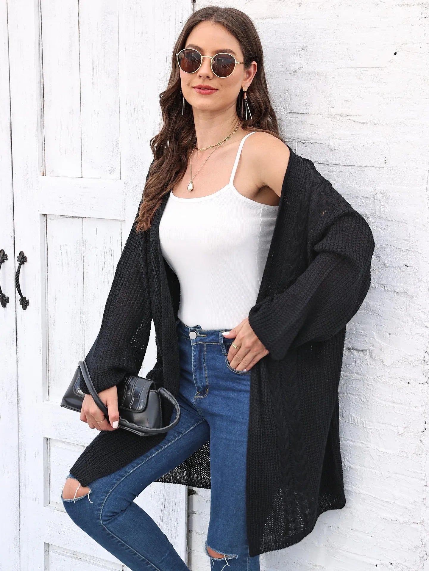 Women's loose fit acrylic sweater coat in a solid colour, shown on a hanger.