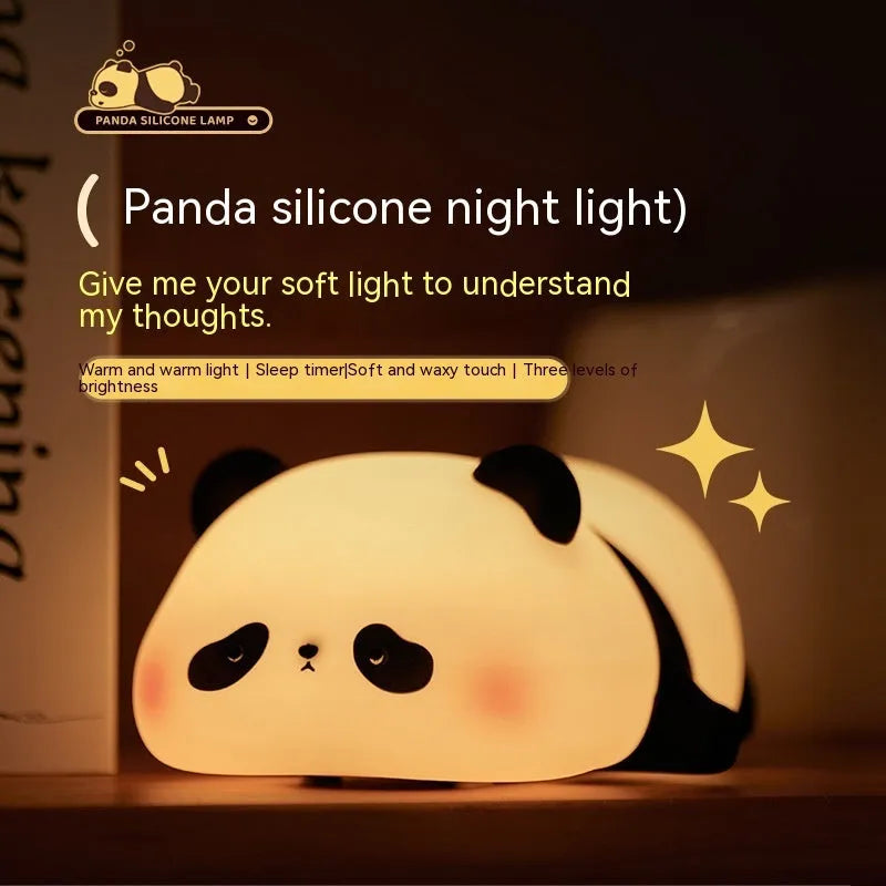 Panda-shaped silicone night light for kids on a bedside table