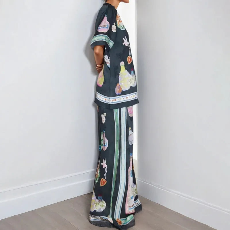 Black women's cardigan and trousers set with cartoon animation print, shown as a two-piece outfit.