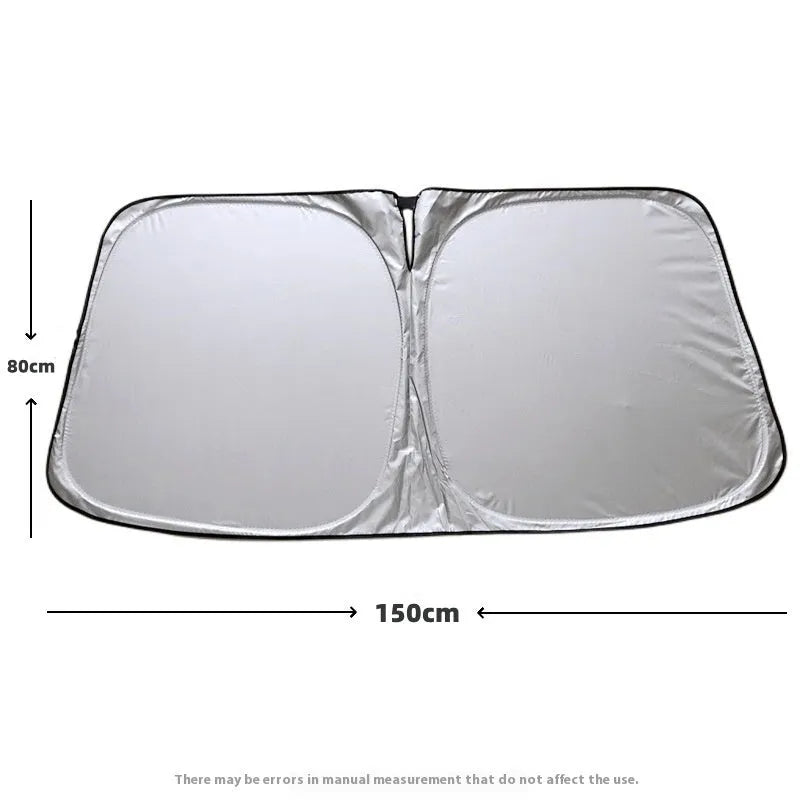 Titanium silver aluminium foil car windscreen sunshade unfolded on a dashboard.