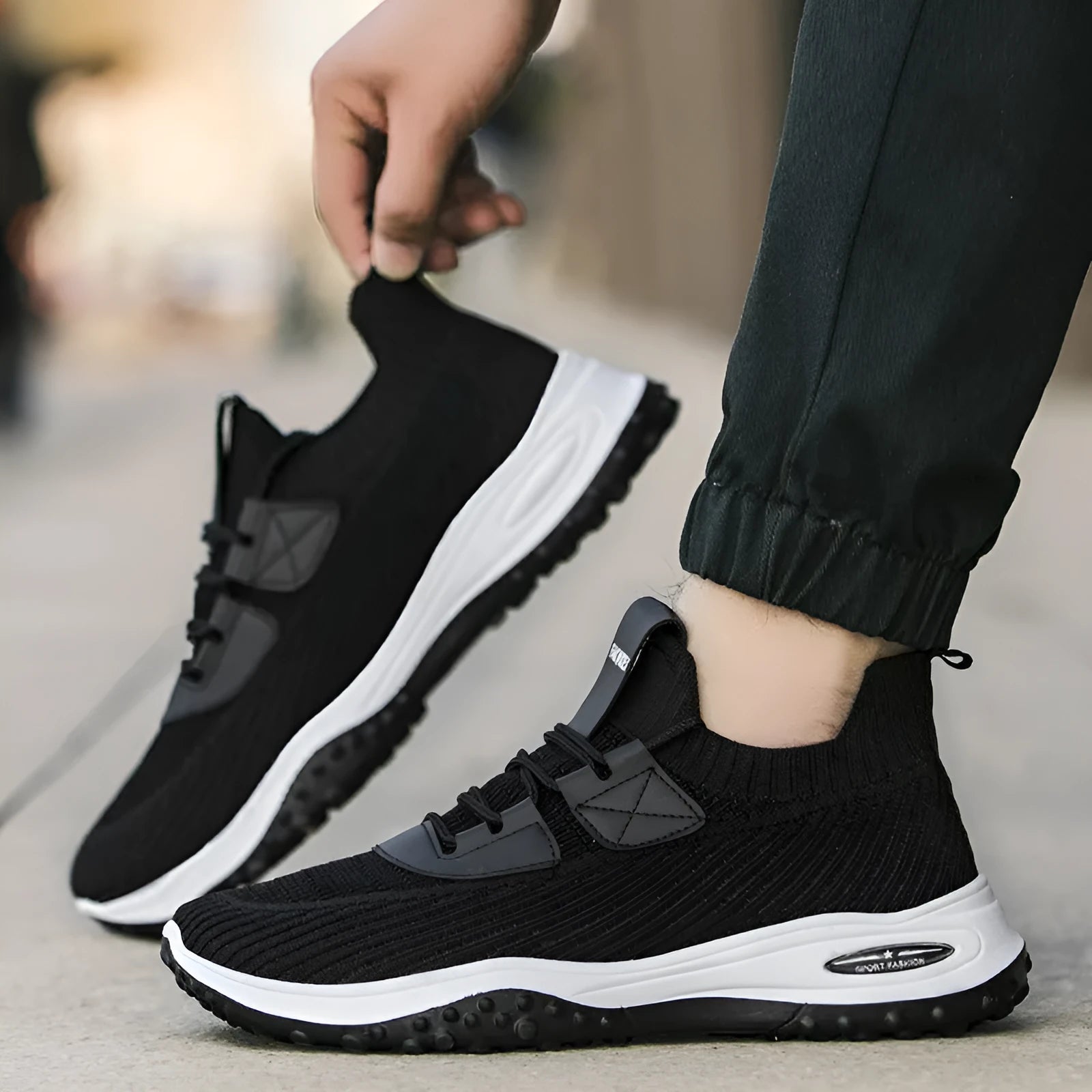 Black Flyknit low top running shoes with mesh lining and plastic sole