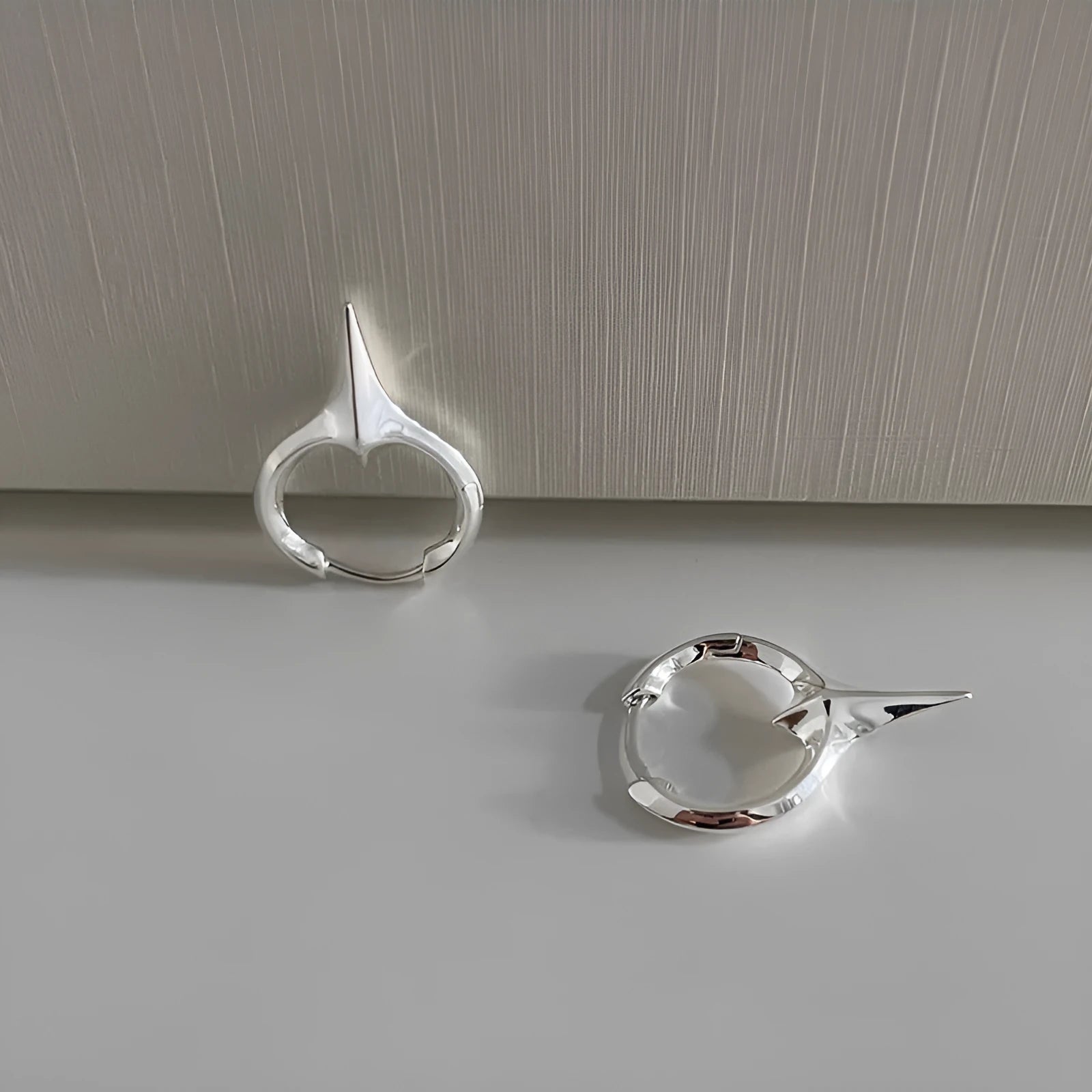 Geometric star stud earrings for women with white gold plated finish on copper.