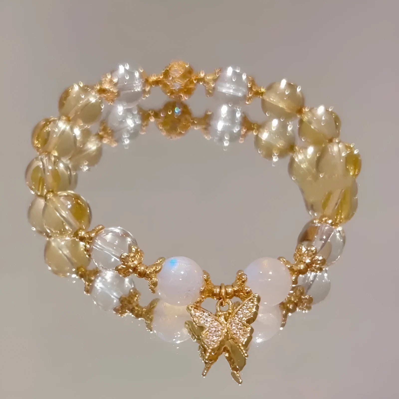 Moonstone white crystal bracelet with citrine butterfly motif and elastic closure
