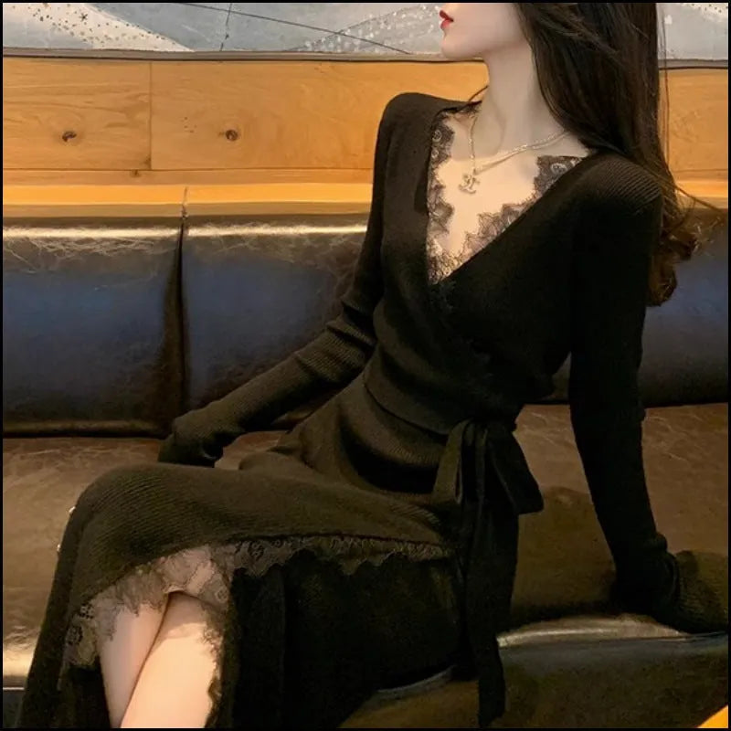 Black slim fit wool skirt dress with a princess A-line silhouette on a hanger.