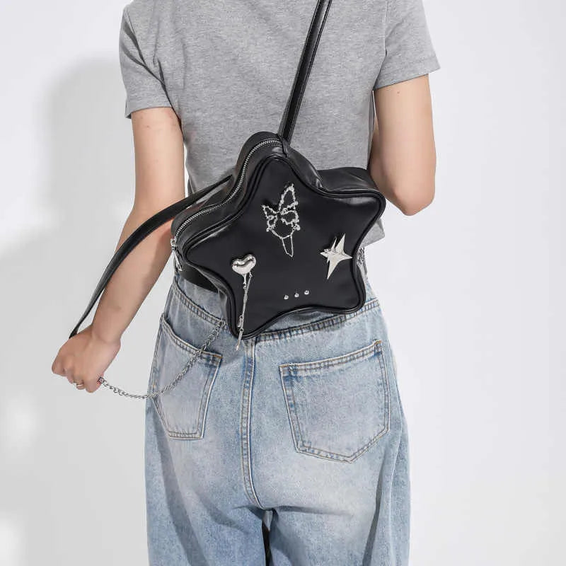 Women's soft black PU leather mini messenger backpack worn crossbody.