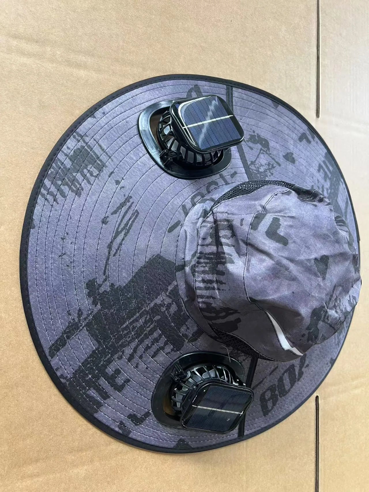 Men's grey solar cooling cap with large eave and visible fan unit on the front.