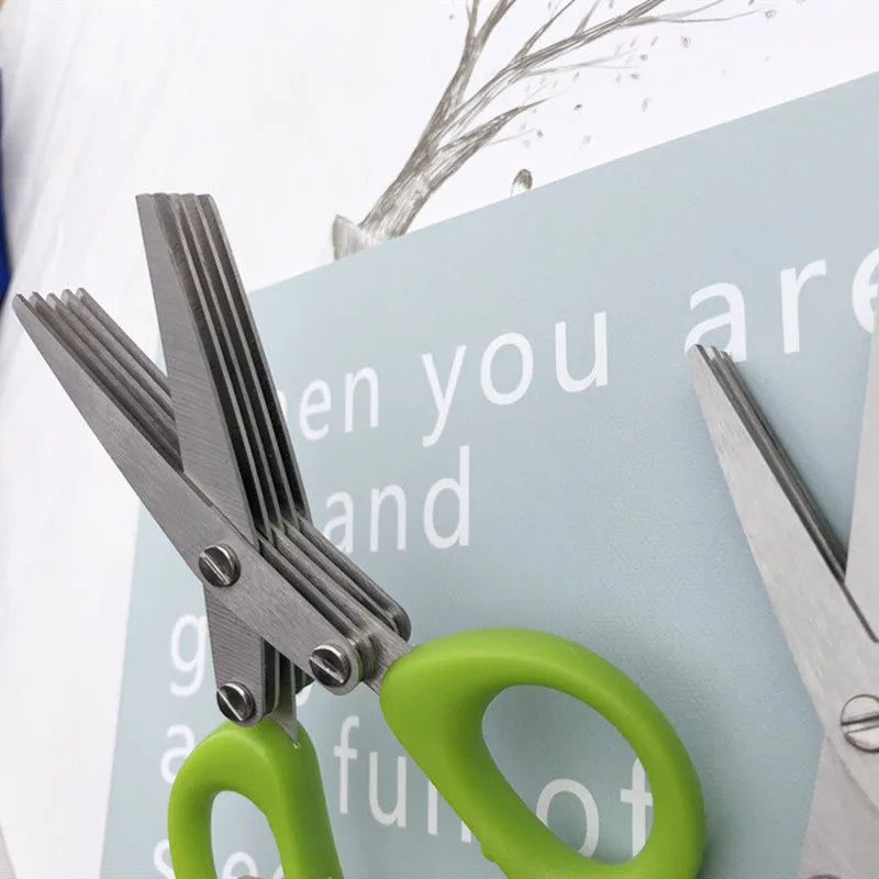 Green stainless steel multi-blade herb scissors with V-shaped design for cutting nori and green onions.
