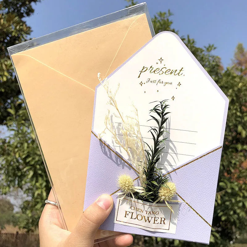 Handmade 3D butterfly-shaped greeting card with artificial flowers in a box, alongside its matching envelope.
