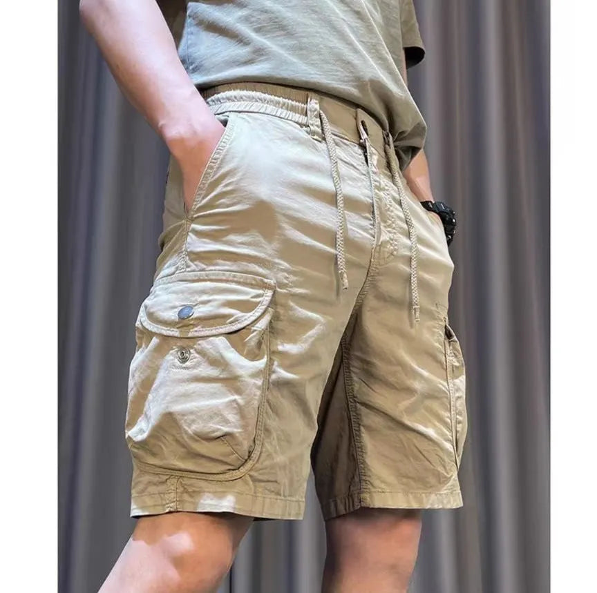 Loose straight-leg multi-pocket casual overalls trousers in khaki colour on a hanger.