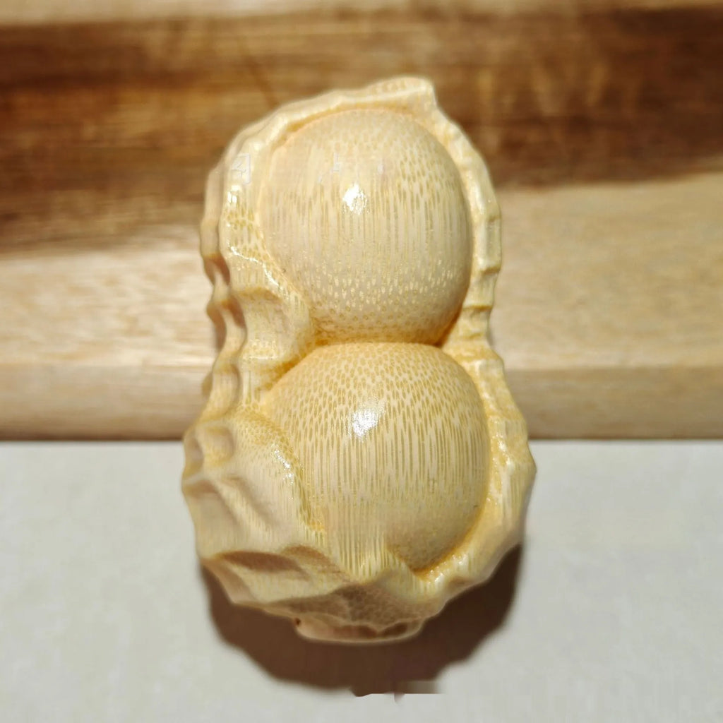 Natural solid bamboo peanut ornament with 'May Good Things Happen' engraved message.