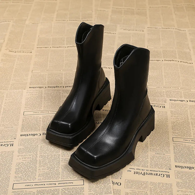 Black women's platform Martin boots with a square toe, high heel, and back zipper on a neutral background.