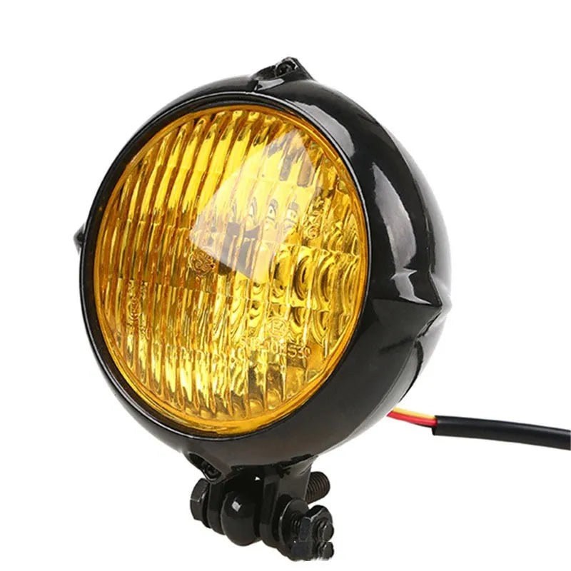 Black electroplated aluminium Harley halogen headlamp with 8cm diameter and yellow glass.