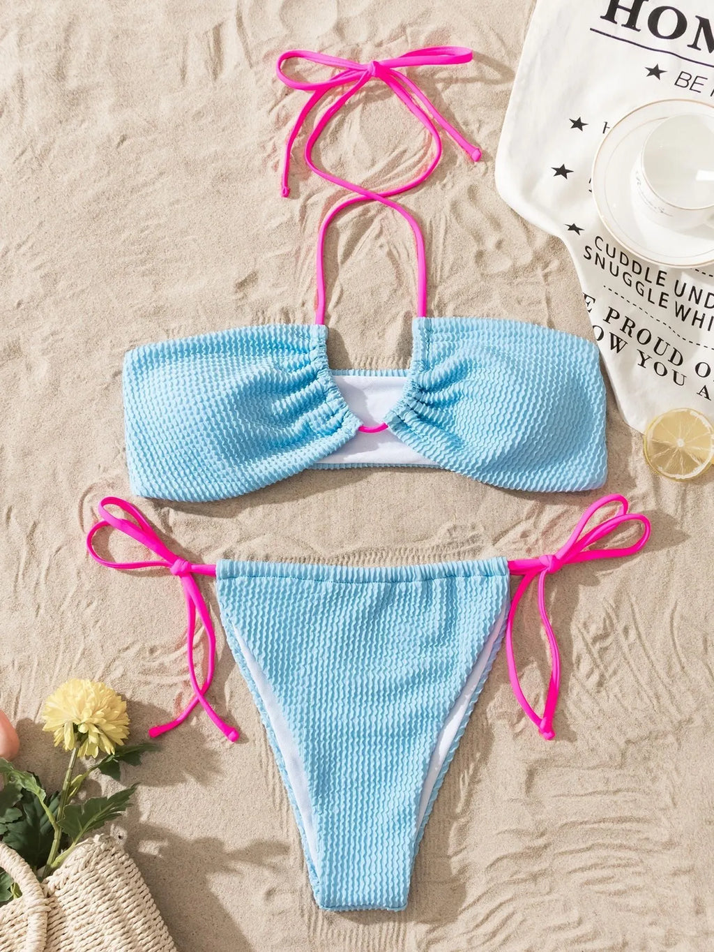 Solid colour women's two-piece swimsuit with halter neck lace-up and backless design.