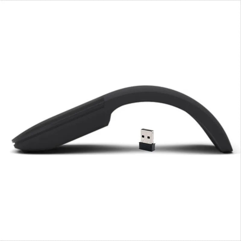 Black folding Bluetooth wireless mouse shown both folded and unfolded beside laptop