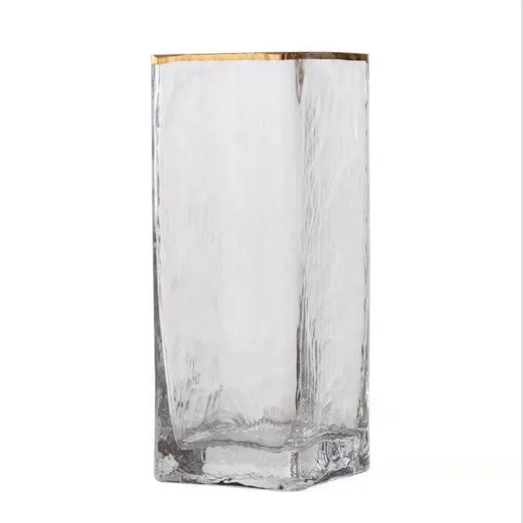 Transparent gold-painted glass vase on table with flower stems, 8x30cm size