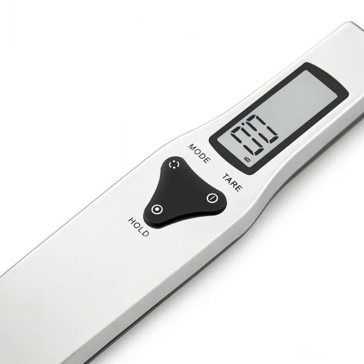 Black digital measuring spoon with LCD display showing weight measurement for kitchen use