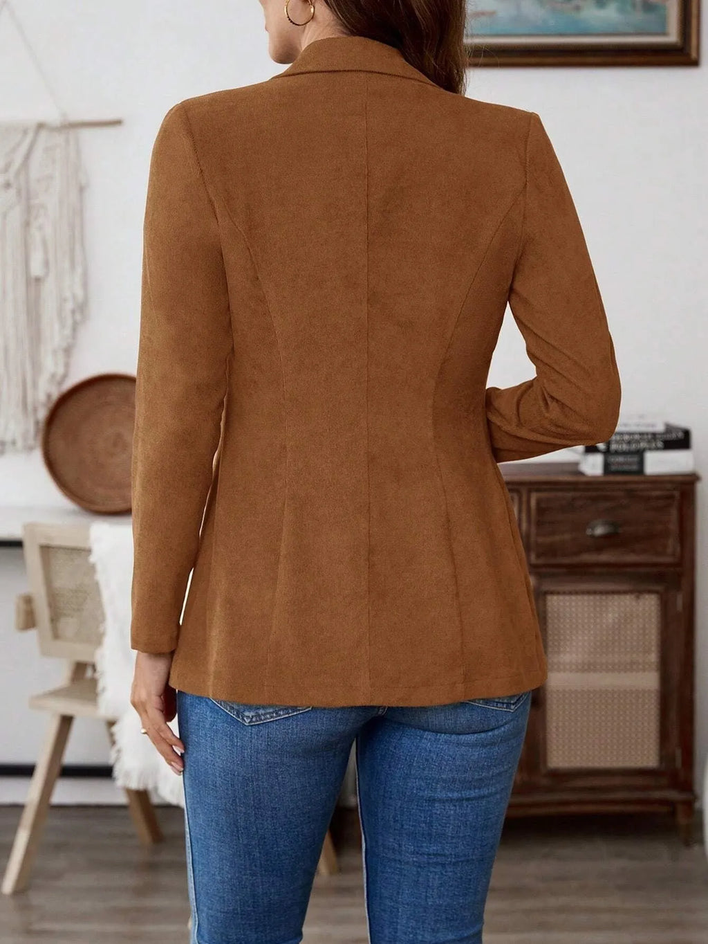 Brown single-breasted lapel leisure suit coat with long sleeves on a hanger