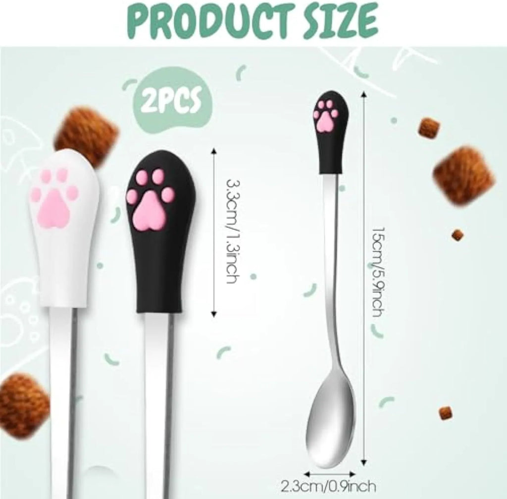 White and black pet food spoons with cat paw designs and silicone handles