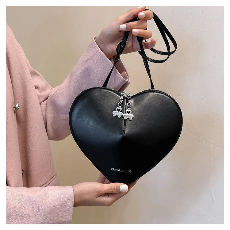 Women's heart-shaped PU crossbody bag in milky white with single shoulder strap and sandwich pocket