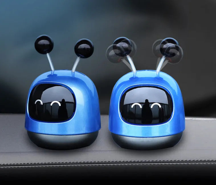 Robot-shaped car vent aromatherapy air freshener diffuser in blue, grey, or red.