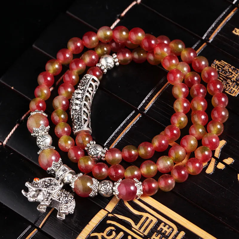 Watermelon crystal bracelet with Chinese knot closure and elephant bead design