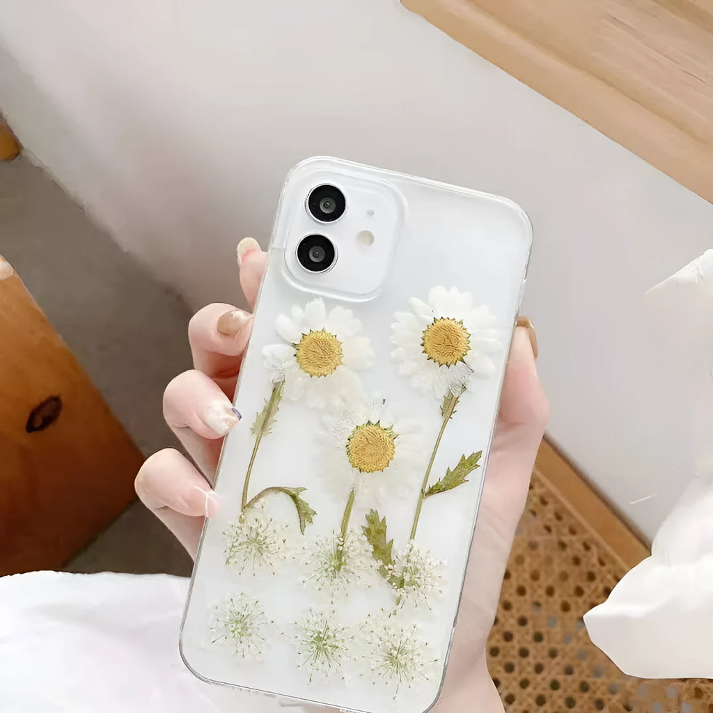 White iPhone case with epoxy daisy floral design on back cover, showing TPU protective construction