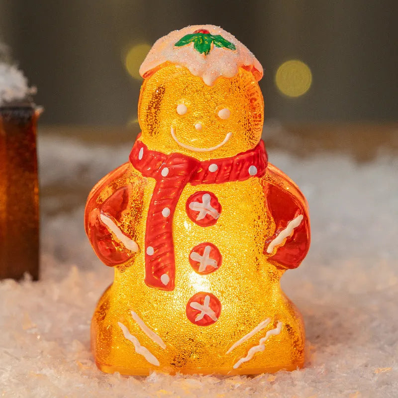 Glowing plastic gingerbread man snowman Christmas ornament with a choice of scarf colours on a festive background.