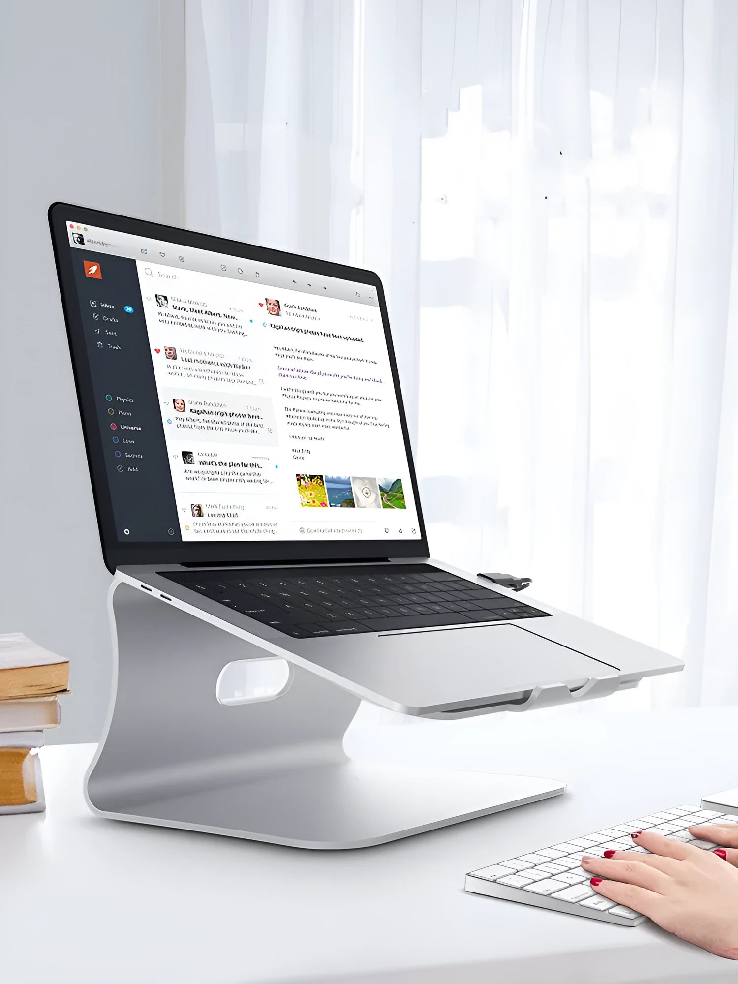 Aluminium alloy rotating laptop cooling bracket in silver or grey colour on a desk.