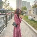 Red knitted cotton dress with elastic high waist, 3/4 princess sleeves, and floral pattern.