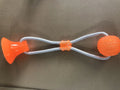 Pet dog rubber sucker molar toy in five colours blue green orange purple red on a light background