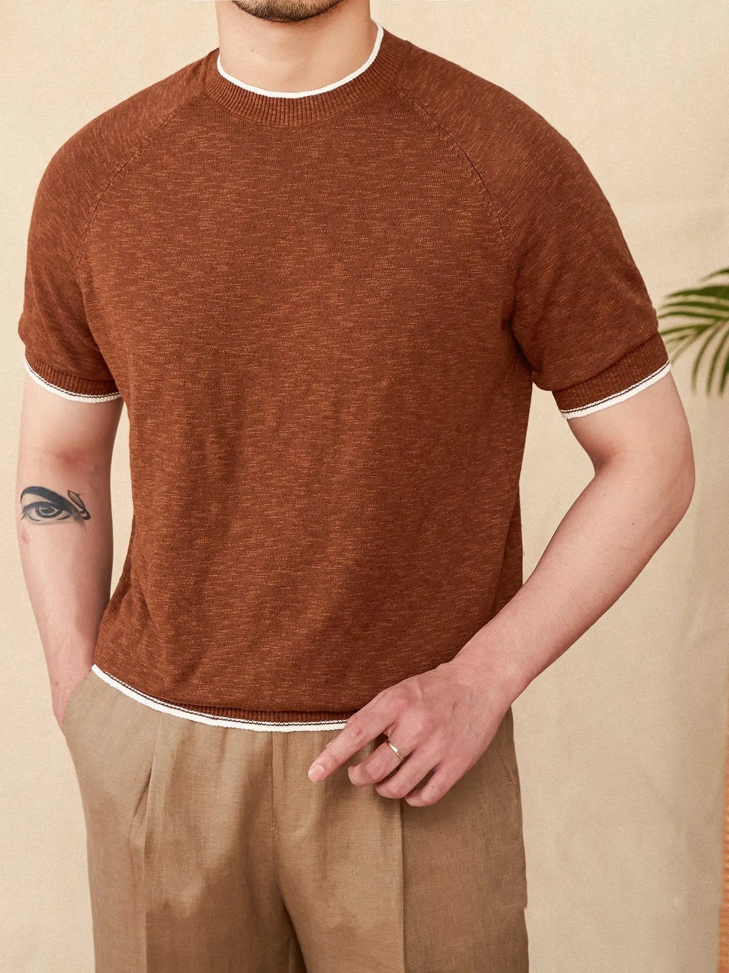 Brown linen cotton casual t-shirt with round neck and short sleeves on hanger