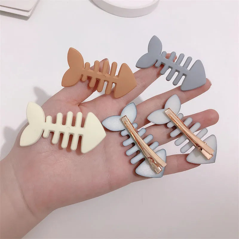 Fishbone pattern plastic barrette with duckbill clip in minimalist candy colour